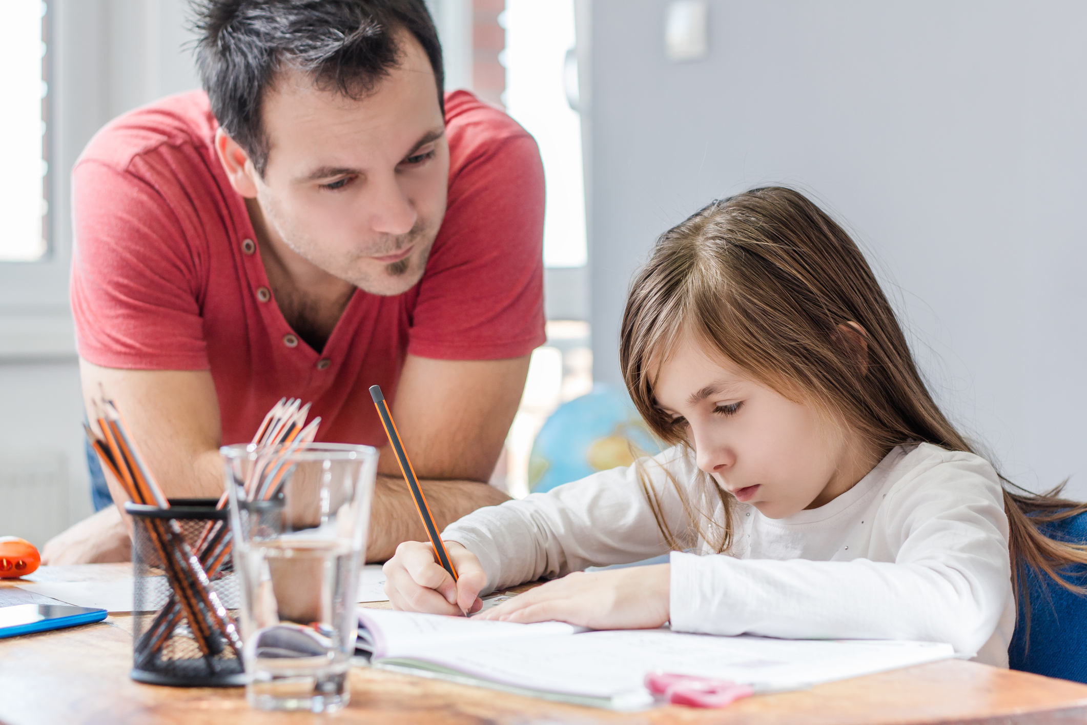 Father Helping Daughter With Homework